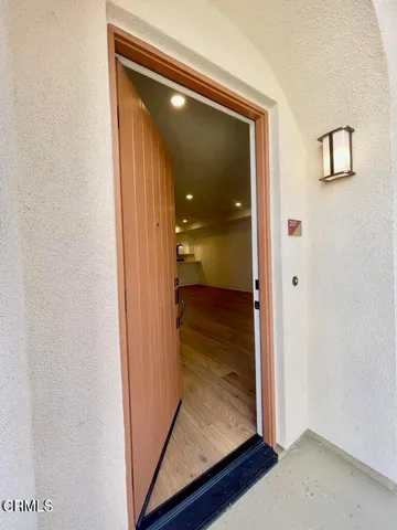 a view of a hallway with wooden floor