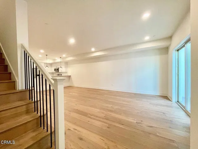 a view of kitchen and empty room