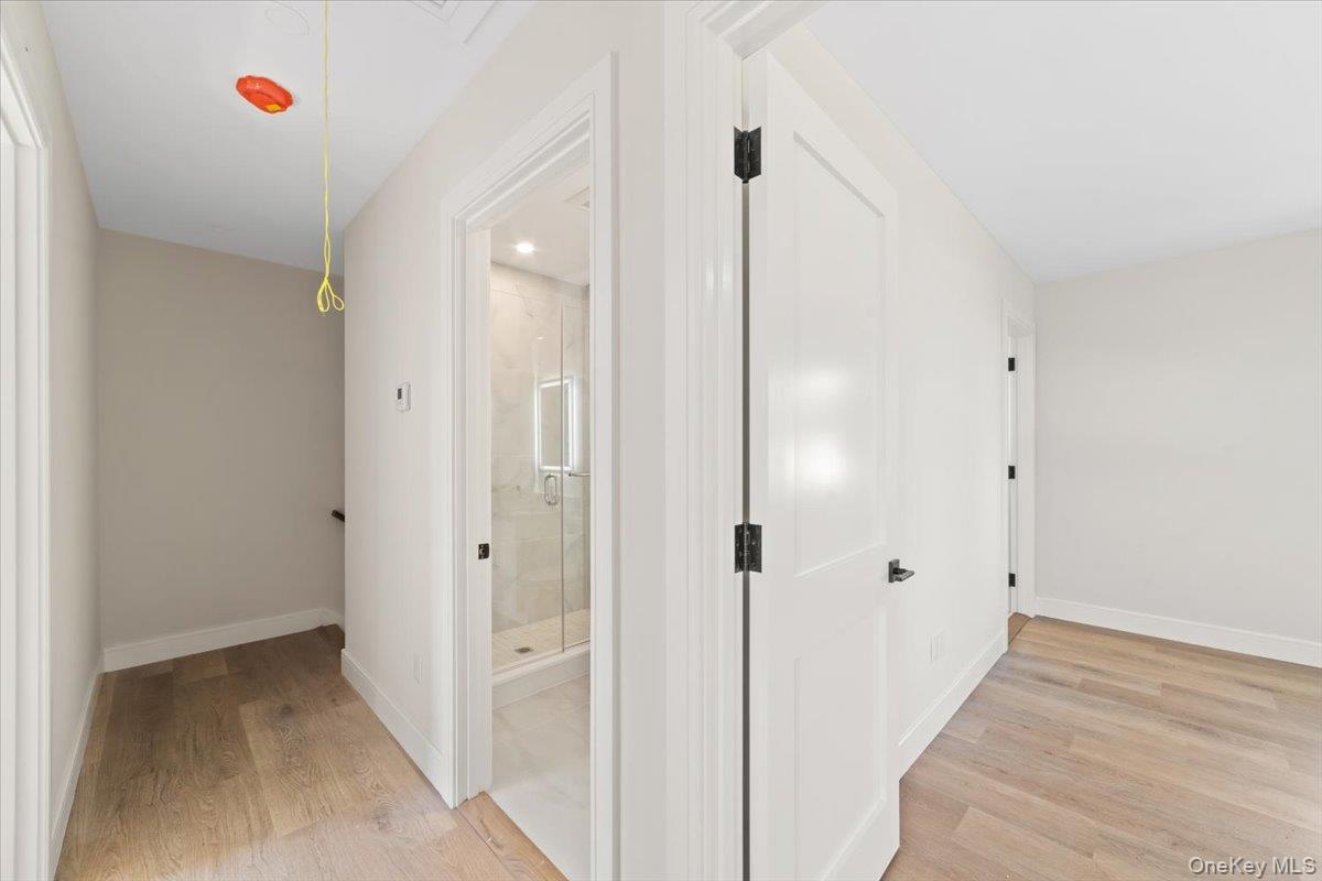 395 5th Avenue New Rochelle, NY 10801 - Photo 11 of 26 a view of a hallway with wooden floor and a bathroom