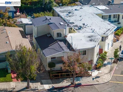 a aerial view of a house with a yard and seating space