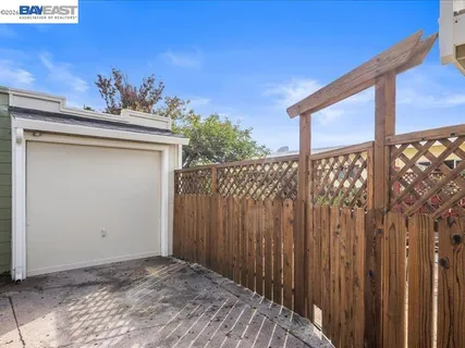 a view of a house with a wooden fence