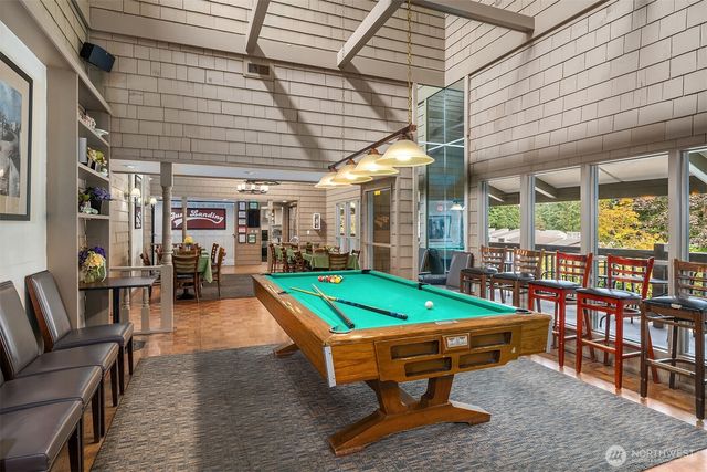 a room with furniture and pool table