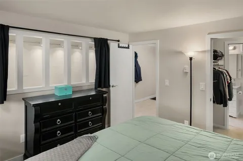 a bedroom with a bed and a mirror