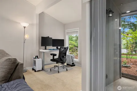 a view of a workspace with furniture and a bedroom