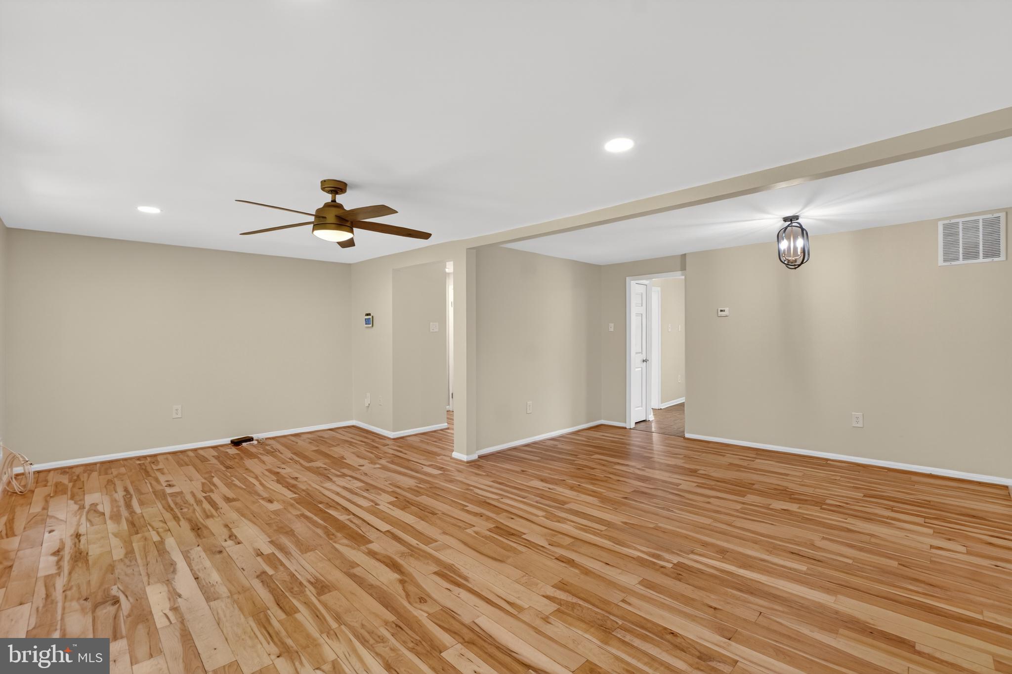 1232 Palmer Road, Unit 111 Fort Washington, MD 20744 - Photo 14 of 45 a view of empty room with wooden floor and ceiling fan