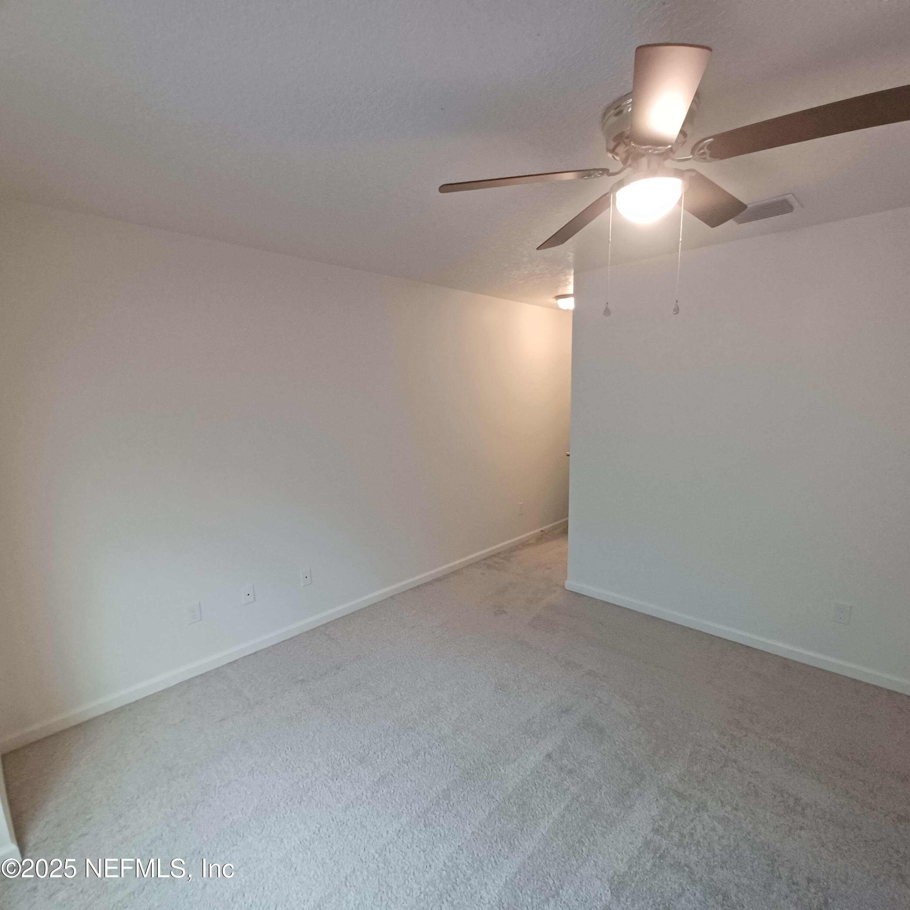 695 Duval Street St. Augustine, FL 32084 - Photo 11 of 20 a view of an empty room and a chandelier fan