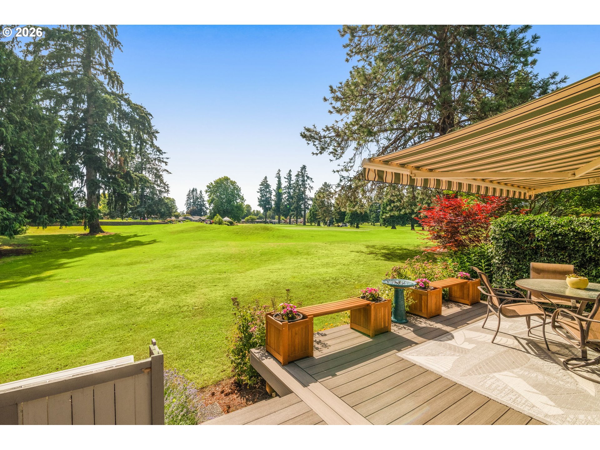 1200 Northeast Territorial Road, Unit 12 Canby, OR 97013 - Photo 17 of 38 a view of a patio with lawn chairs under an umbrella