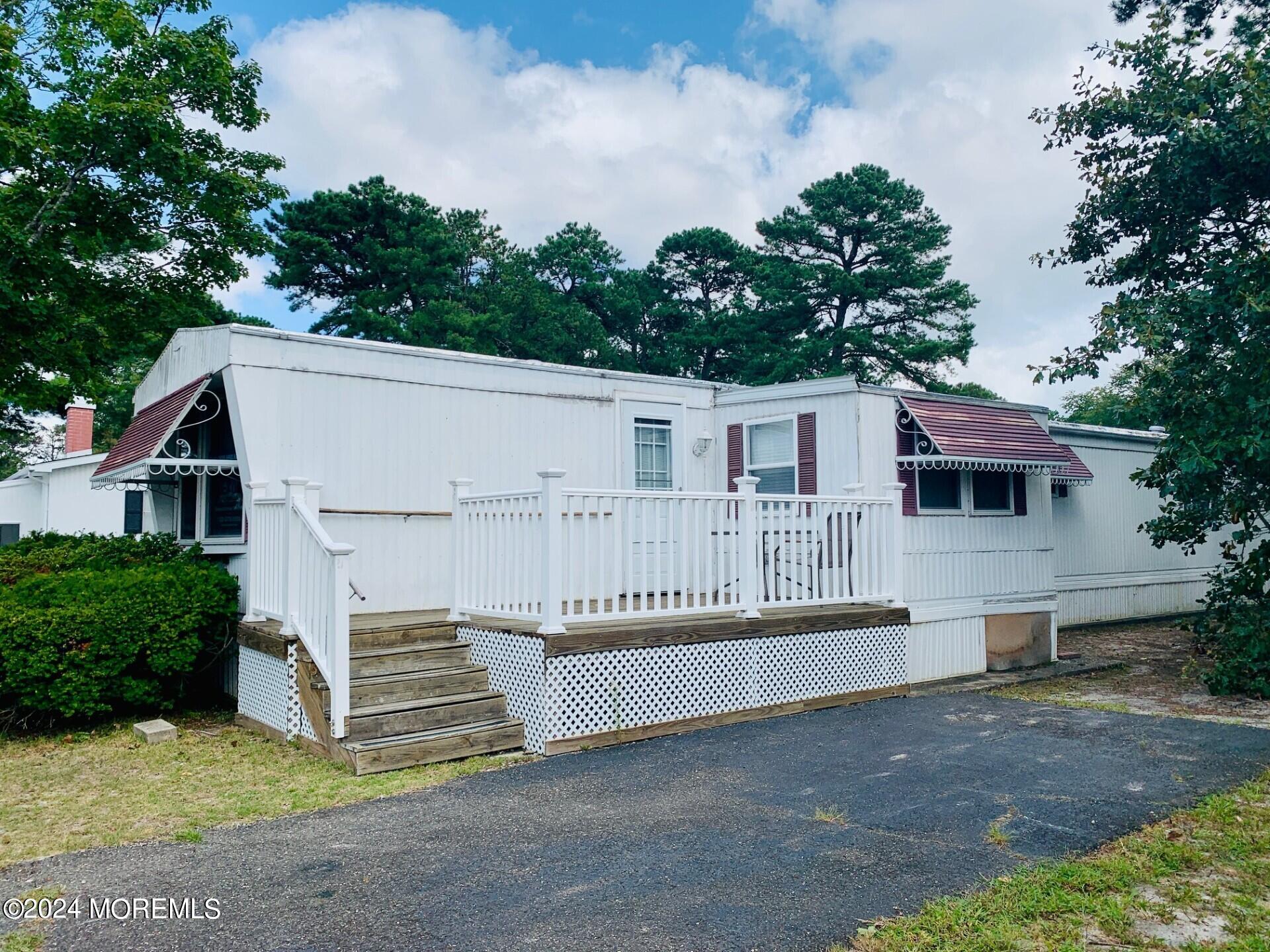 31 Panda Lane Whiting, NJ 08759 - Photo 2 of 16 a white house that has a tree in front of it