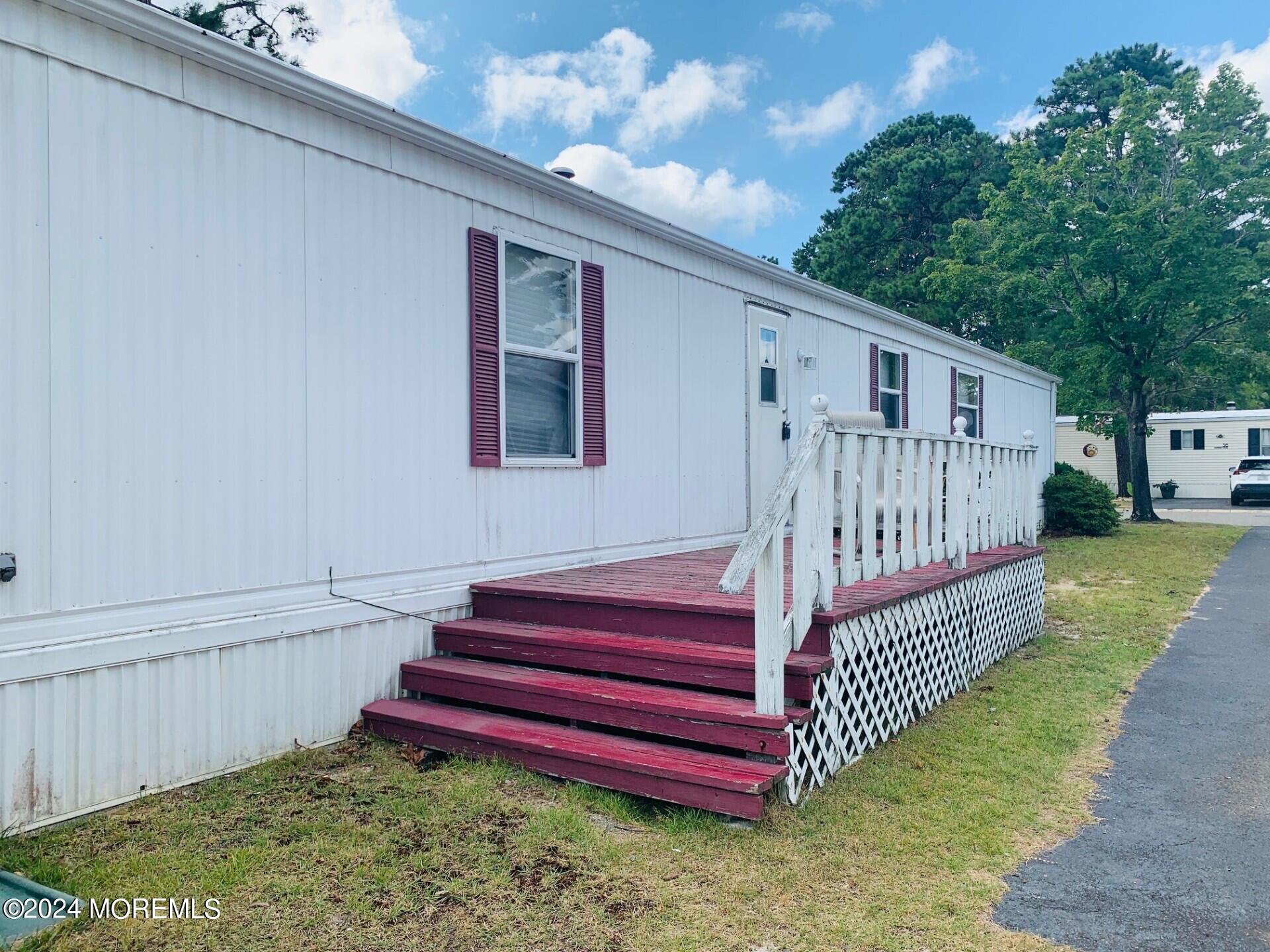 31 Panda Lane Whiting, NJ 08759 - Photo 3 of 16 a view of a deck with a yard