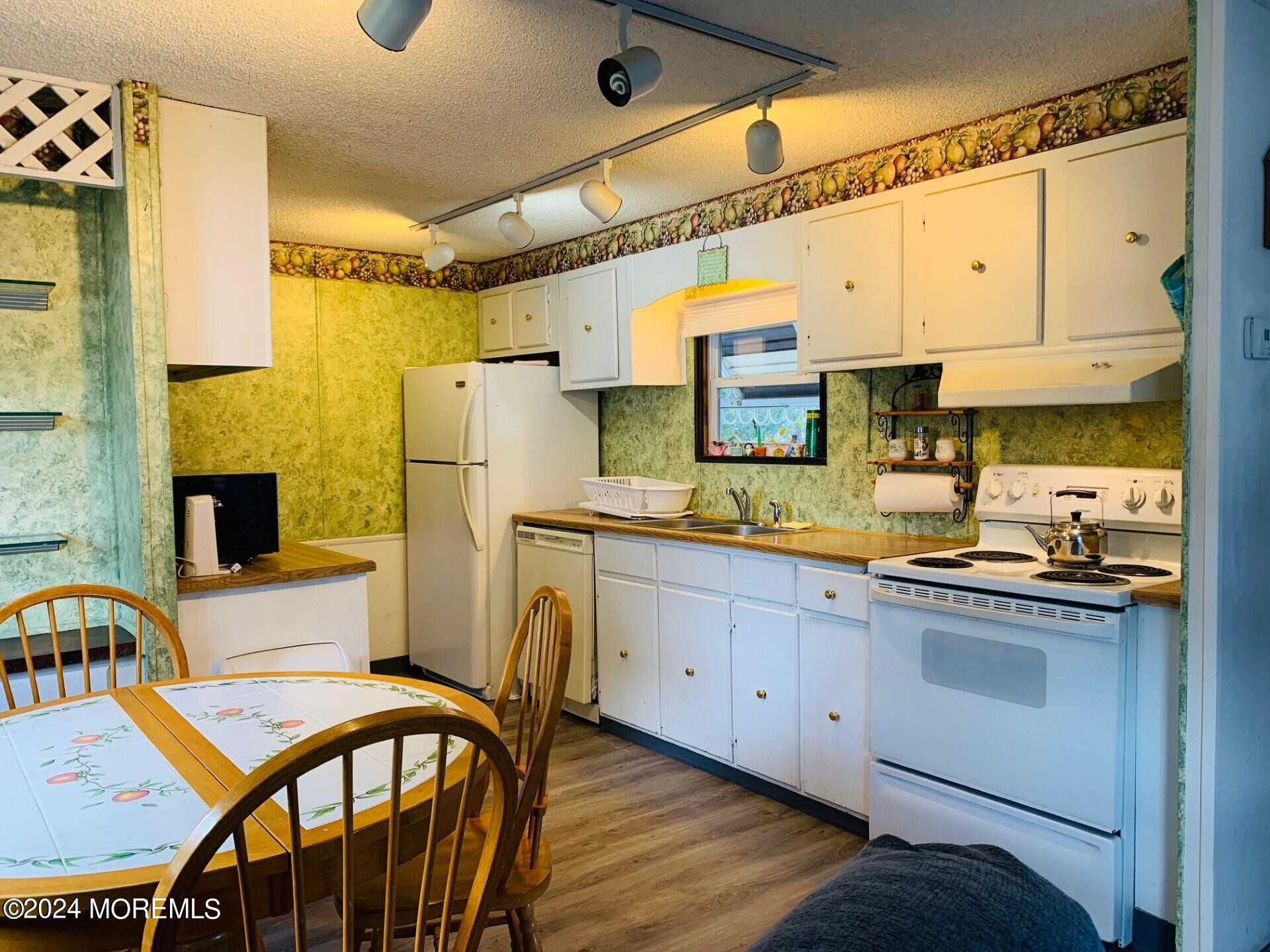 31 Panda Lane Whiting, NJ 08759 - Photo 9 of 16 a kitchen with stainless steel appliances granite countertop a sink a stove a refrigerator with a dining table and chairs