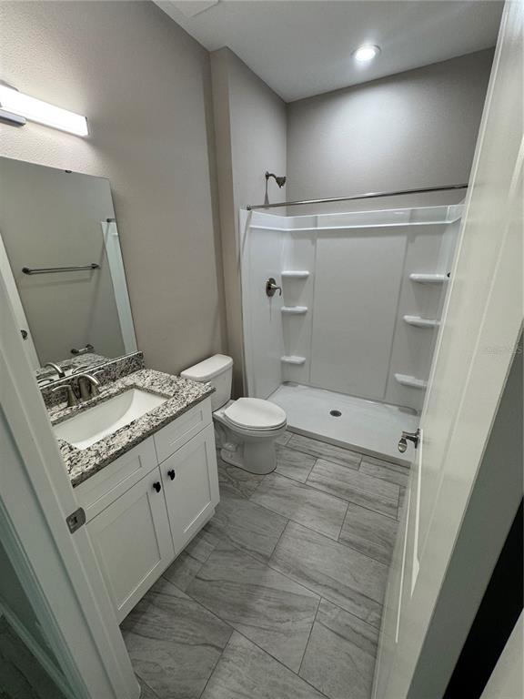 5238 2nd Street Orlando, FL 32810 - Photo 17 of 19 a bathroom with a granite countertop sink toilet and shower