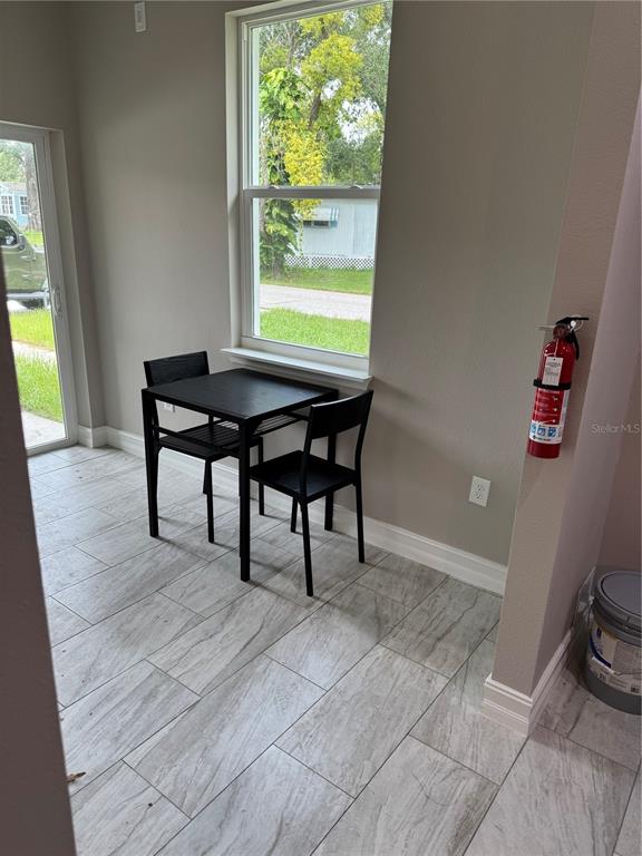 5238 2nd Street Orlando, FL 32810 - Photo 5 of 19 a view of a workspace with furniture and a window