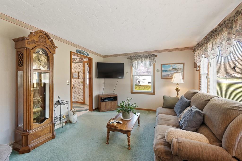 1065 Turnpike Road Ashby, MA 01431 - Photo 8 of 23 a living room with furniture fireplace and a flat screen tv