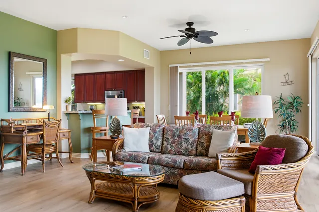 a living room with fireplace furniture and a large window