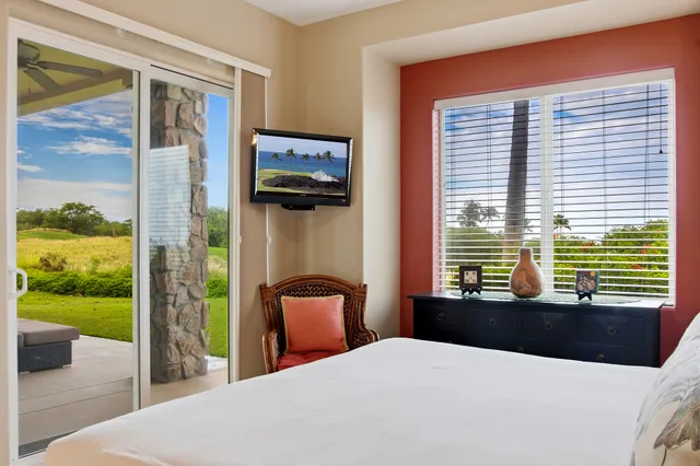 a bedroom with a large bed and a balcony view