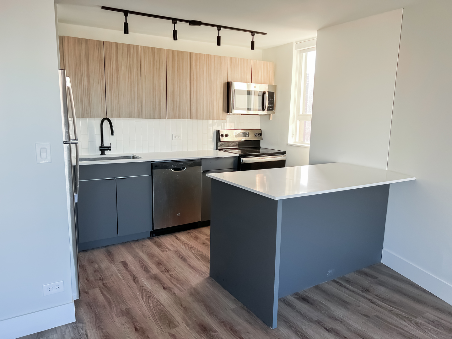 Undisclosed Address Chicago, IL 60611 - Photo 5 of 11 a kitchen with stainless steel appliances a sink stove and refrigerator