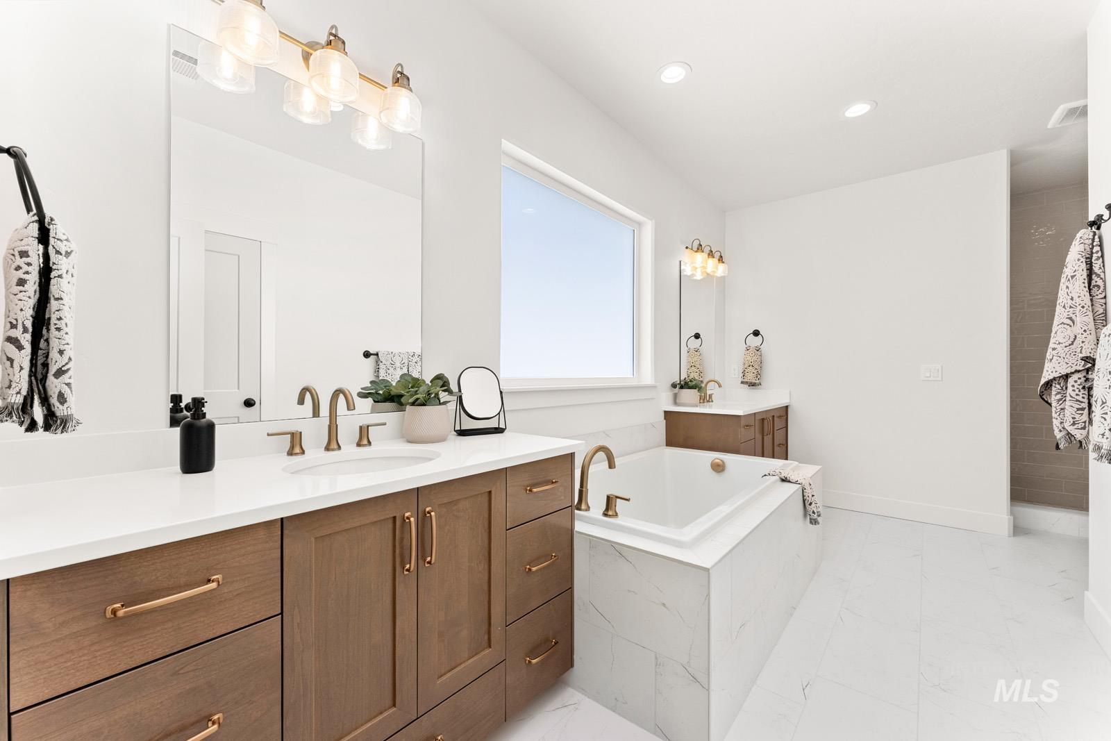 13344 North Spring Creek Way Boise, ID 83714 - Photo 16 of 39 Bathroom featuring vanity, a bath, and recessed lighting