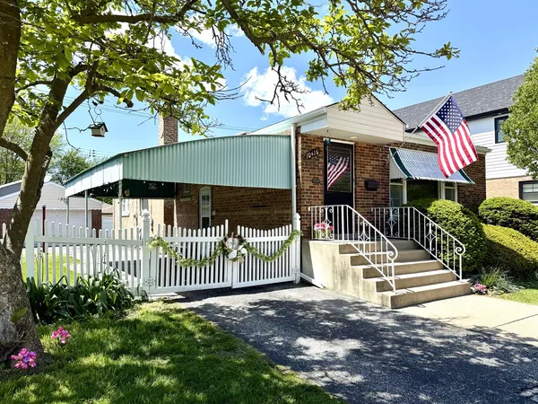 a view of a house with a yard and flower plants