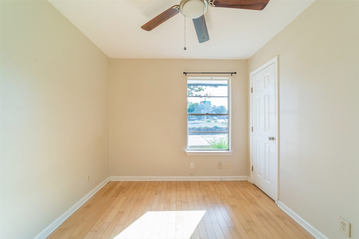1738 Rutland Drive, Unit A Austin, TX 78758 - Photo 16 of 30 a view of an empty room with wooden floor and a window