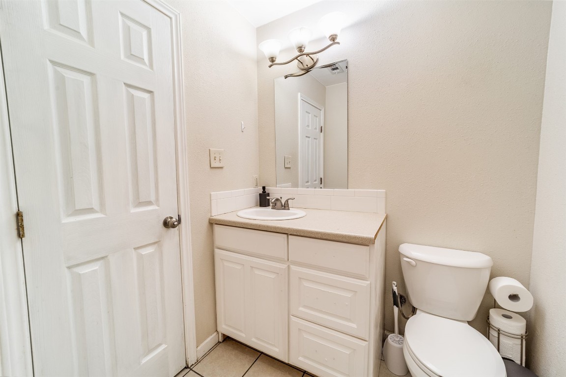 1738 Rutland Drive, Unit A Austin, TX 78758 - Photo 24 of 30 a bathroom with a toilet sink and mirror