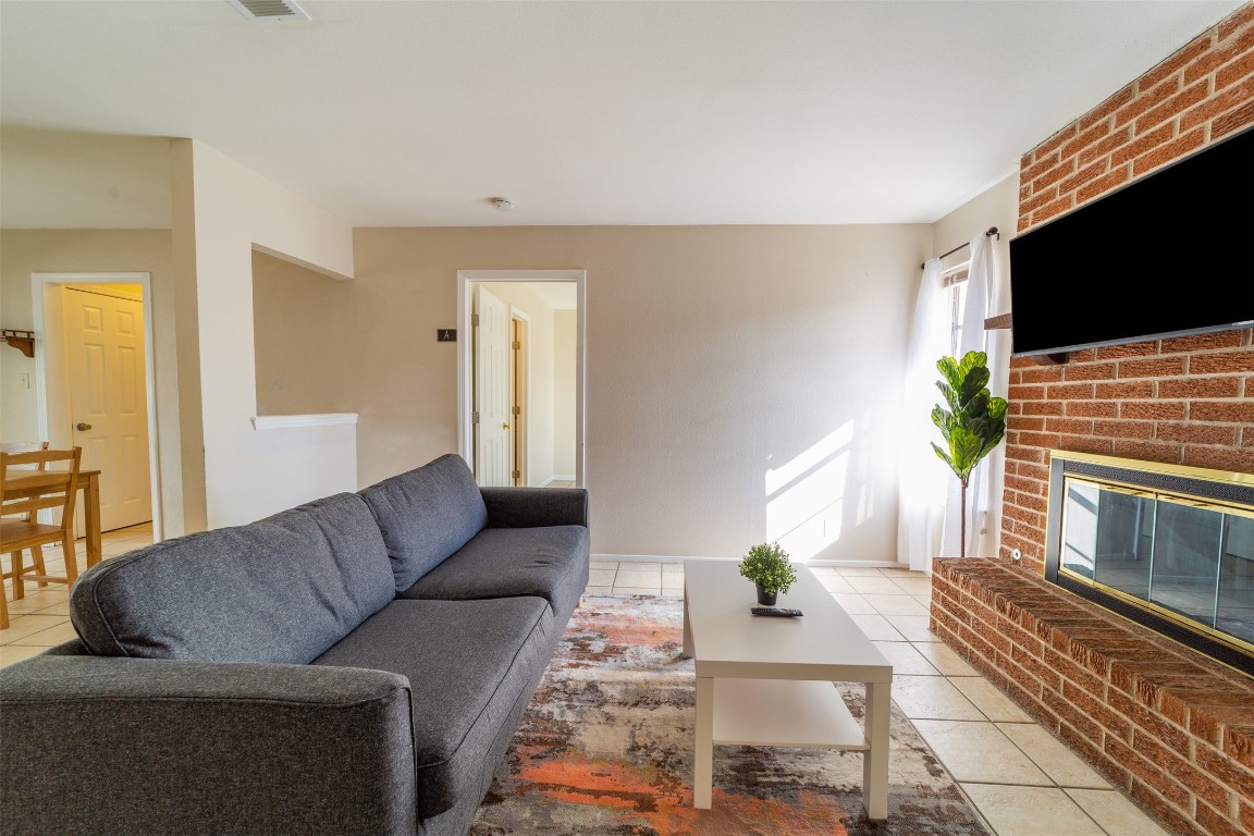 1738 Rutland Drive, Unit A Austin, TX 78758 - Photo 6 of 30 a living room with furniture and a flat screen tv