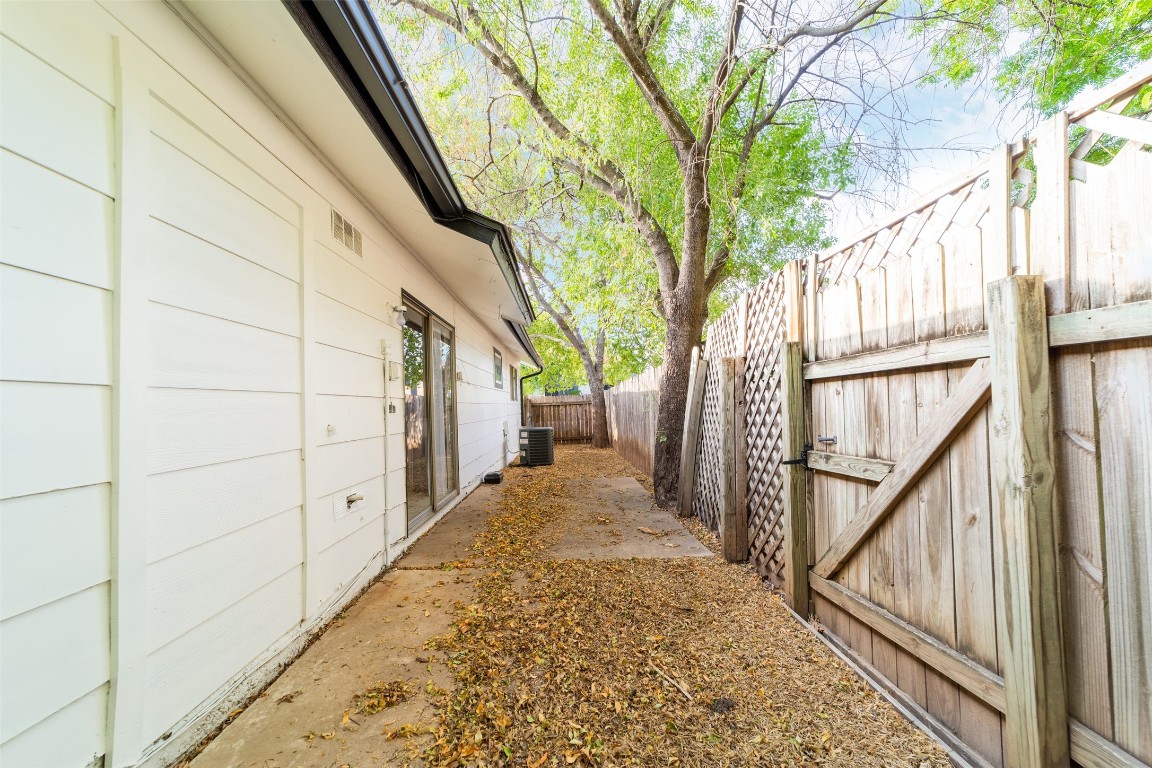 1738 Rutland Drive, Unit A Austin, TX 78758 - Photo 7 of 30 a view of a pathway of a house with wooden fence