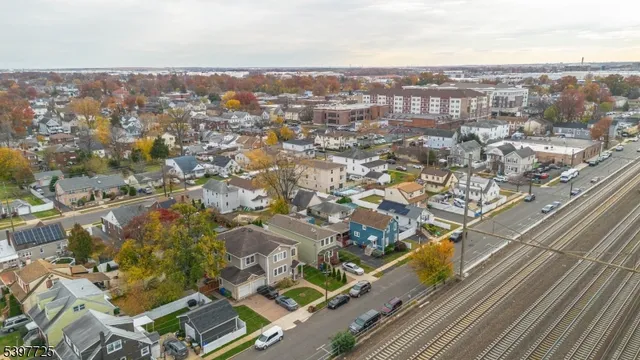an aerial view of residential houses with city view