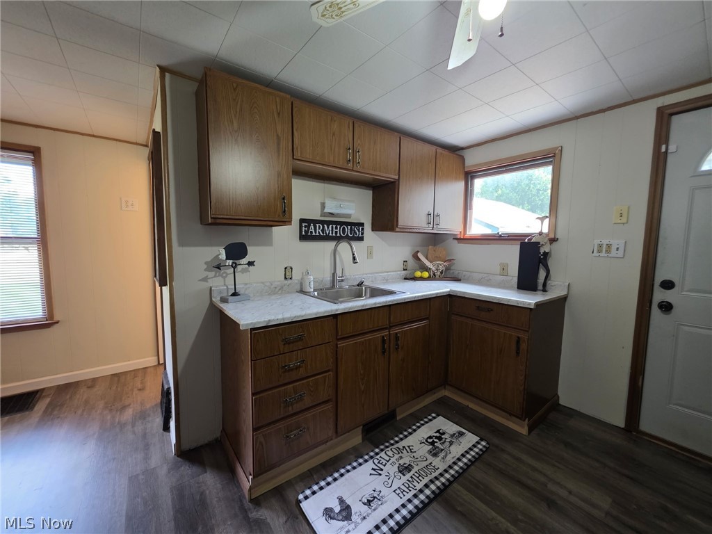 2335 West River Road Newton Falls, OH 44444 - Photo 12 of 36 Kitchen featuring wood-finish cabinetry, light-toned countertops, and a stainless steel sink with a gooseneck faucet