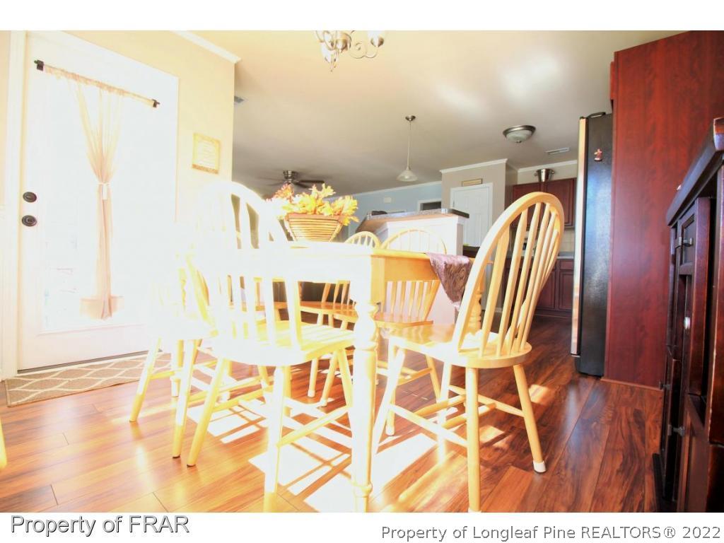 698 Cape Fear Road Raeford, NC 28376 - Photo 6 of 24 a dining room with furniture and wooden floor