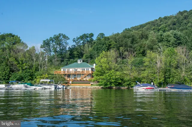 a swimming pool with outdoor seating and yard