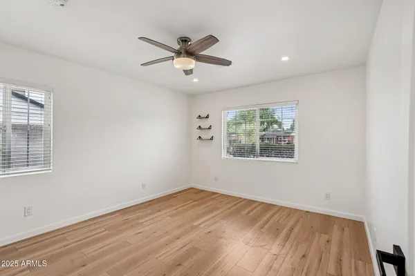a view of empty room with wooden floor