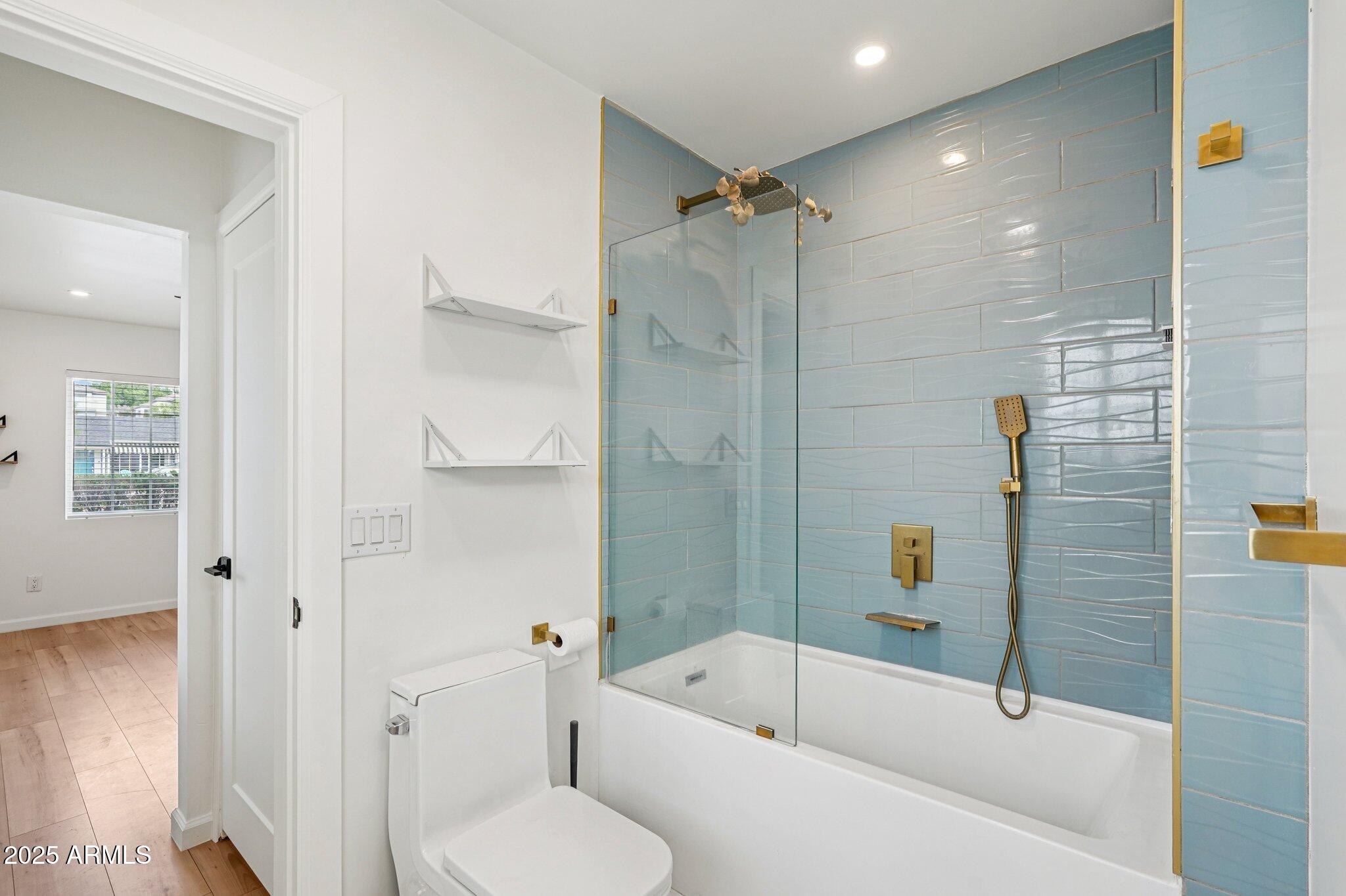 511 East Cheery Lynn Road Phoenix, AZ 85012 - Photo 16 of 33 a bathroom with a tub toilet and shower