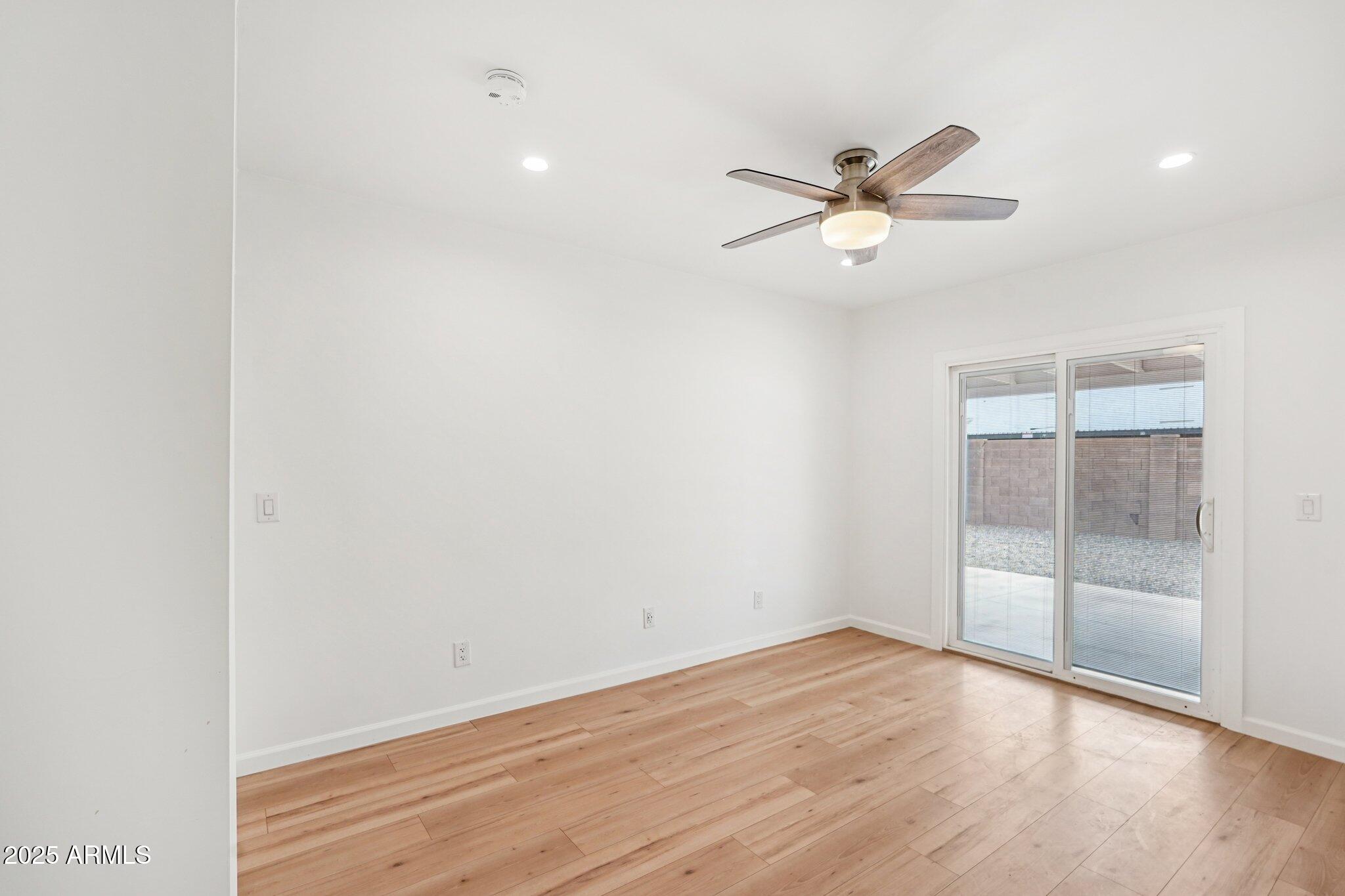 511 East Cheery Lynn Road Phoenix, AZ 85012 - Photo 19 of 33 an empty room with wooden floor and windows