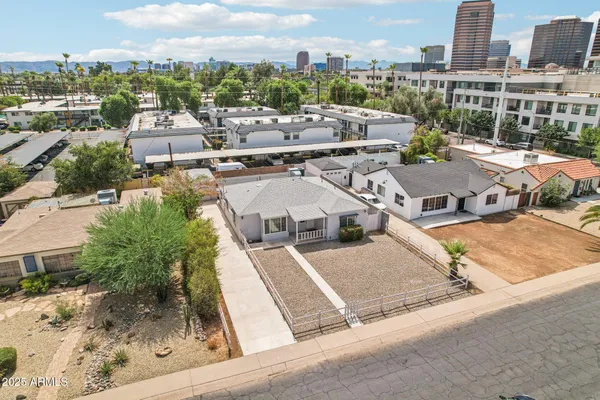 an aerial view of residential houses with outdoor space and parking
