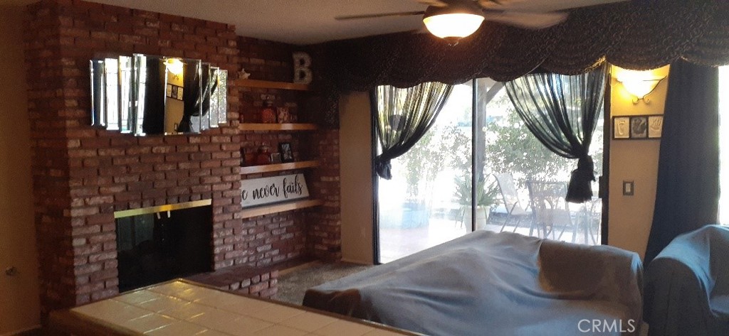 1484 Pepper Tree Drive Hemet, CA 92545 - Photo 11 of 24 Great room with fireplace and golf green belt views