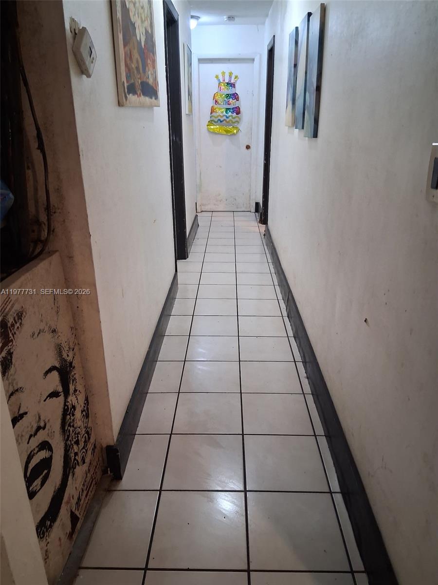 960 Southwest 13th Court Miami, FL 33135 - Photo 12 of 15 a hallway with painting on the wall and a mirror
