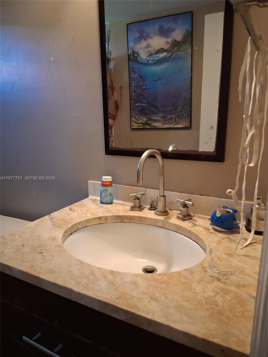 960 Southwest 13th Court Miami, FL 33135 - Photo 2 of 15 a bathroom with a sink and a mirror
