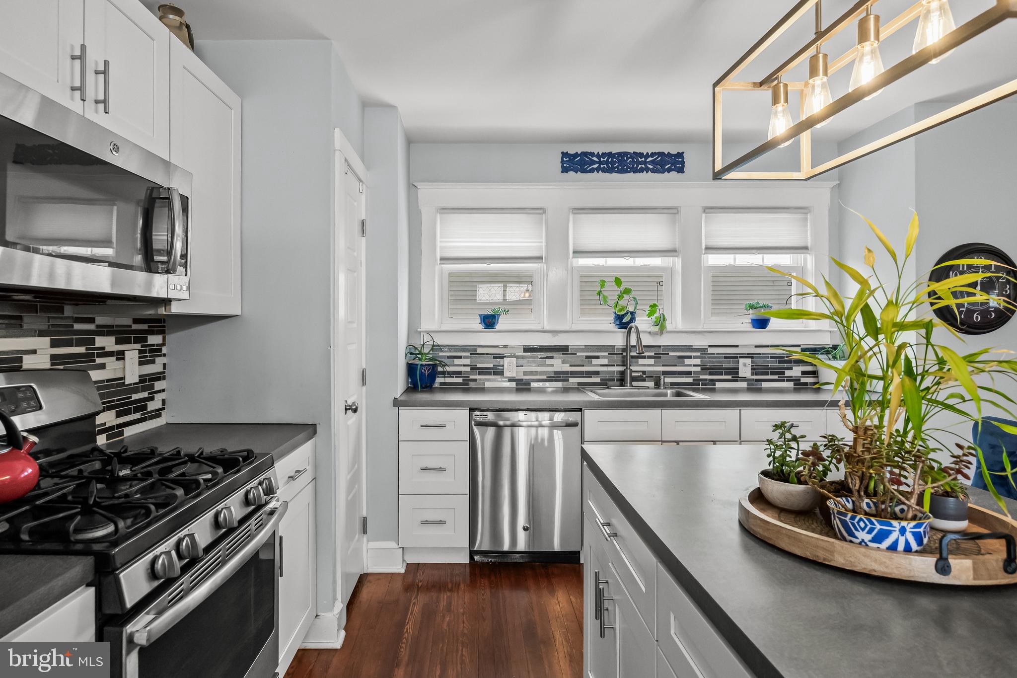 615 North Walnut Avenue Magnolia, NJ 08049 - Photo 13 of 40 a kitchen with stainless steel appliances a stove a sink and a microwave