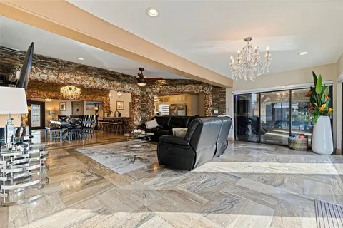 a view of a dining room with furniture and a chandelier