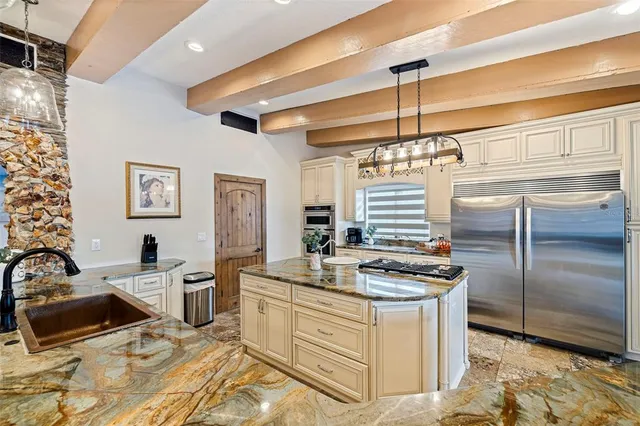a kitchen with stove a refrigerator and chairs