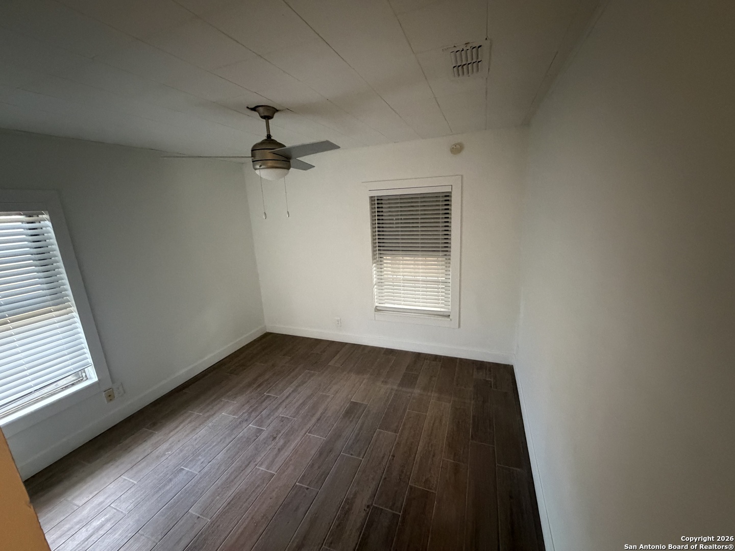 1635 Basse Road San Antonio, TX 78213 - Photo 12 of 17 an empty room with wooden floor ceiling fan and windows