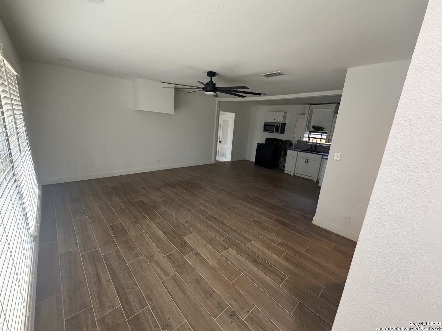 1635 Basse Road San Antonio, TX 78213 - Photo 4 of 17 wooden floor in an empty room with a window