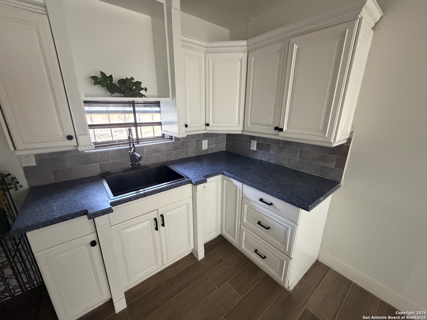 1635 Basse Road San Antonio, TX 78213 - Photo 6 of 17 a kitchen with stainless steel appliances white cabinets and a window