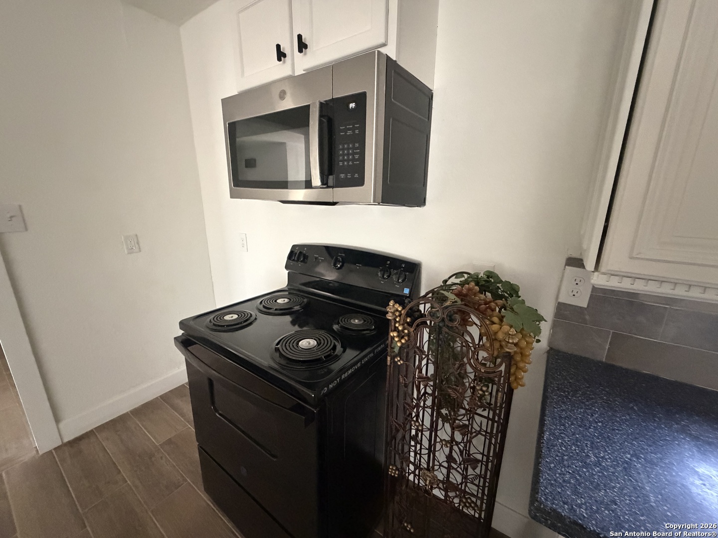 1635 Basse Road San Antonio, TX 78213 - Photo 7 of 17 a kitchen with a stove and a microwave