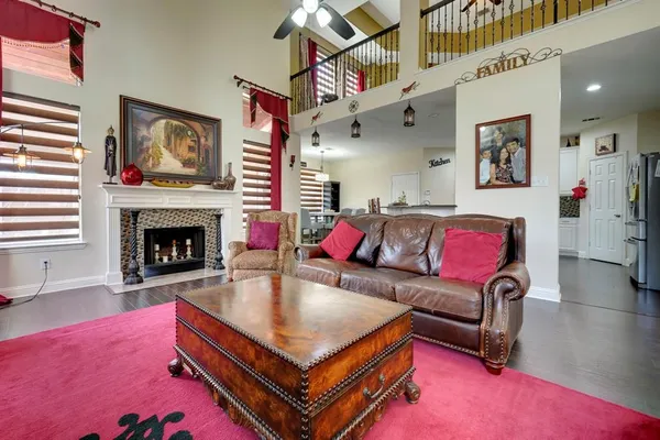 a living room with furniture a flat screen tv and a fireplace