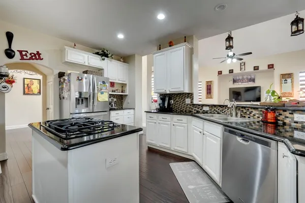 a kitchen with stainless steel appliances a stove a sink and a refrigerator