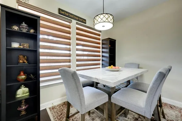 a view of a dining room with furniture and chandelier