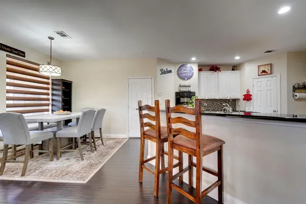 a view of a dining room with furniture and a chandelier