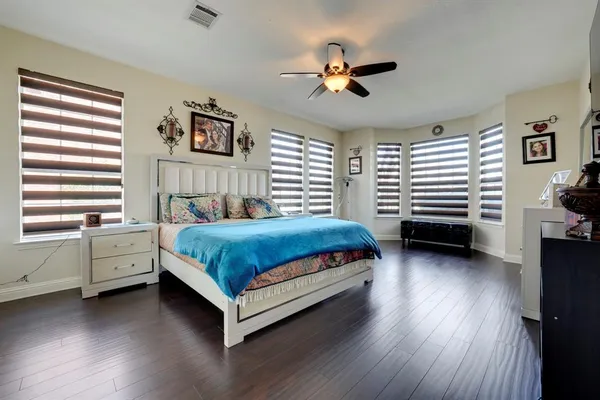 a bedroom with a bed and a chandelier