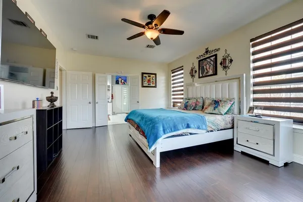 a bedroom with a bed and a chandelier